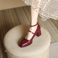 Black Sophie ankle-strap pumps by THE WHITMORE FAMILY, elegant sandal with a sleek design and stylish heel.