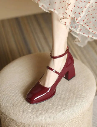 Black Sophie ankle-strap pumps by THE WHITMORE FAMILY, elegant sandal with a sleek design and stylish heel.