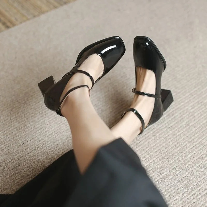 Black Sophie ankle-strap pumps by THE WHITMORE FAMILY, elegant sandal with a sleek design and open toe.