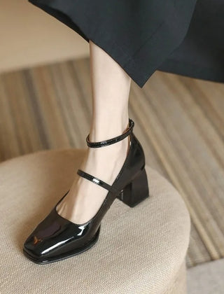 Black Sophie ankle-strap pumps by THE WHITMORE FAMILY, elegant sandal with a sleek design and comfortable heel.