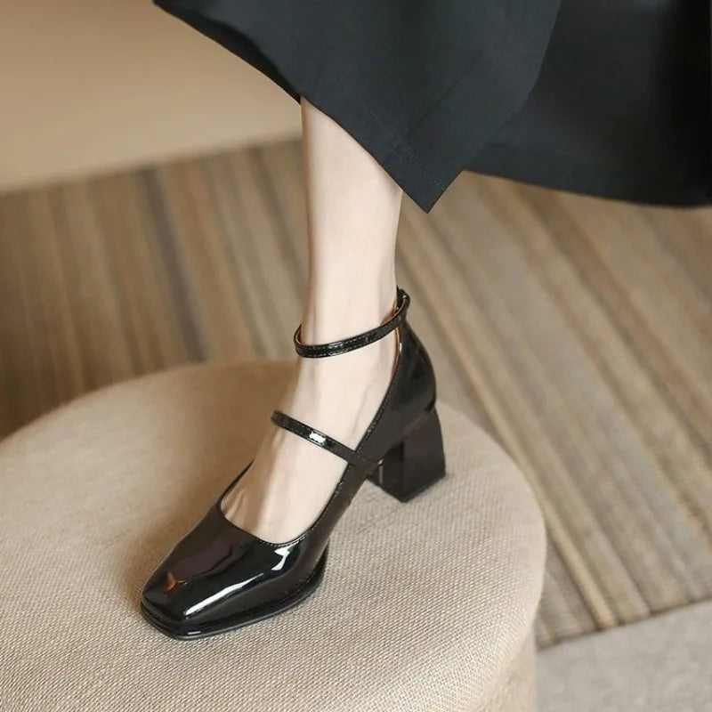 Black Sophie ankle-strap pumps by THE WHITMORE FAMILY, elegant sandal with a sleek design and comfortable heel.