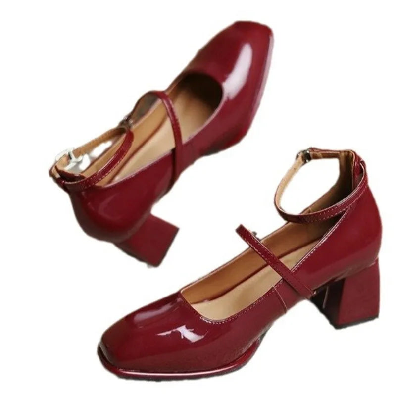 Black Sophie ankle-strap pumps by THE WHITMORE FAMILY, elegant sandal with a stylish strap design and pointed toe.