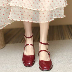 Black Sophie ankle-strap pumps by THE WHITMORE FAMILY, elegant sandal with a sleek design and comfortable heel.