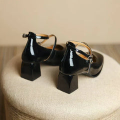 Black Sophie ankle-strap pumps by THE WHITMORE FAMILY, elegant sandal with stylish ankle strap and pointed toe.