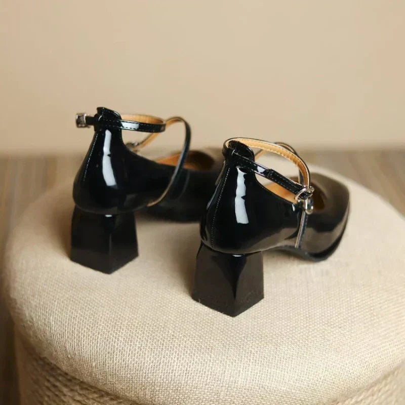 Black Sophie ankle-strap pumps by THE WHITMORE FAMILY, elegant sandal with stylish ankle strap and pointed toe.