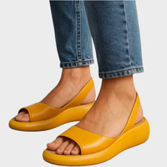 Yellow Caryzzaa™ orthopedic sandals by THE WHITMORE FAMILY, featuring cushioned straps and supportive sole for comfortable wear.
