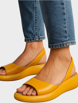 Yellow Caryzzaa™ orthopedic sandals by THE WHITMORE FAMILY, featuring cushioned straps and supportive sole for comfortable wear.