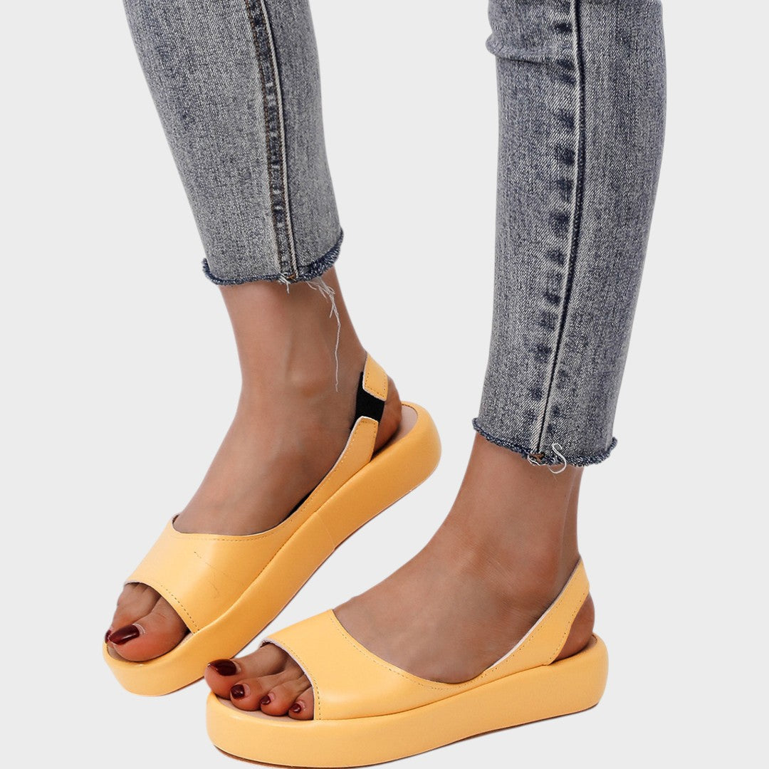 Yellow Caryzzaa™ orthopedic sandals by THE WHITMORE FAMILY with cushioned straps and supportive soles for comfortable wear.