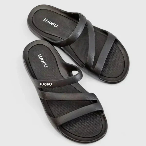Black Daryell™ orthopedic sandals by THE WHITMORE FAMILY with supportive footbed and adjustable straps, designed for comfort.