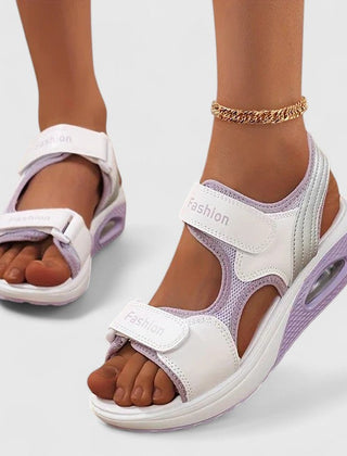 White and black Rhea™ Cushy Sandals by THE WHITMORE FAMILY with padded straps and comfortable sole, casual footwear for warm weather.