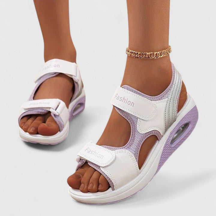 White and black Rhea™ Cushy Sandals by THE WHITMORE FAMILY with padded straps and comfortable sole, casual footwear for warm weather.