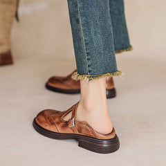 Brown Matea elegant Mary Jane shoes by THE WHITMORE FAMILY, featuring classic strap design and polished finish.