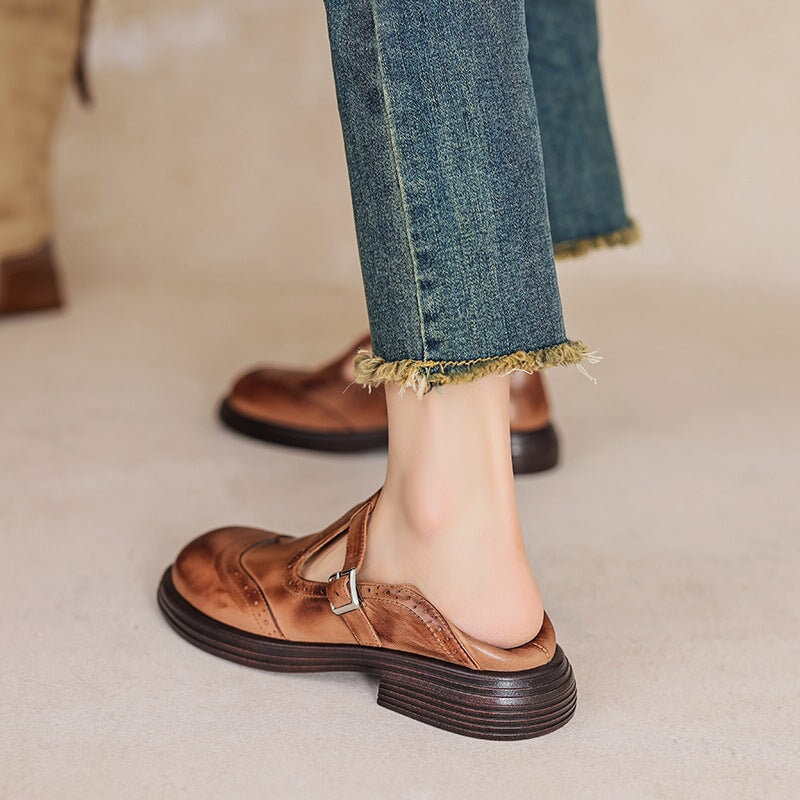 Brown Matea elegant Mary Jane shoes by THE WHITMORE FAMILY, featuring classic strap design and polished finish.