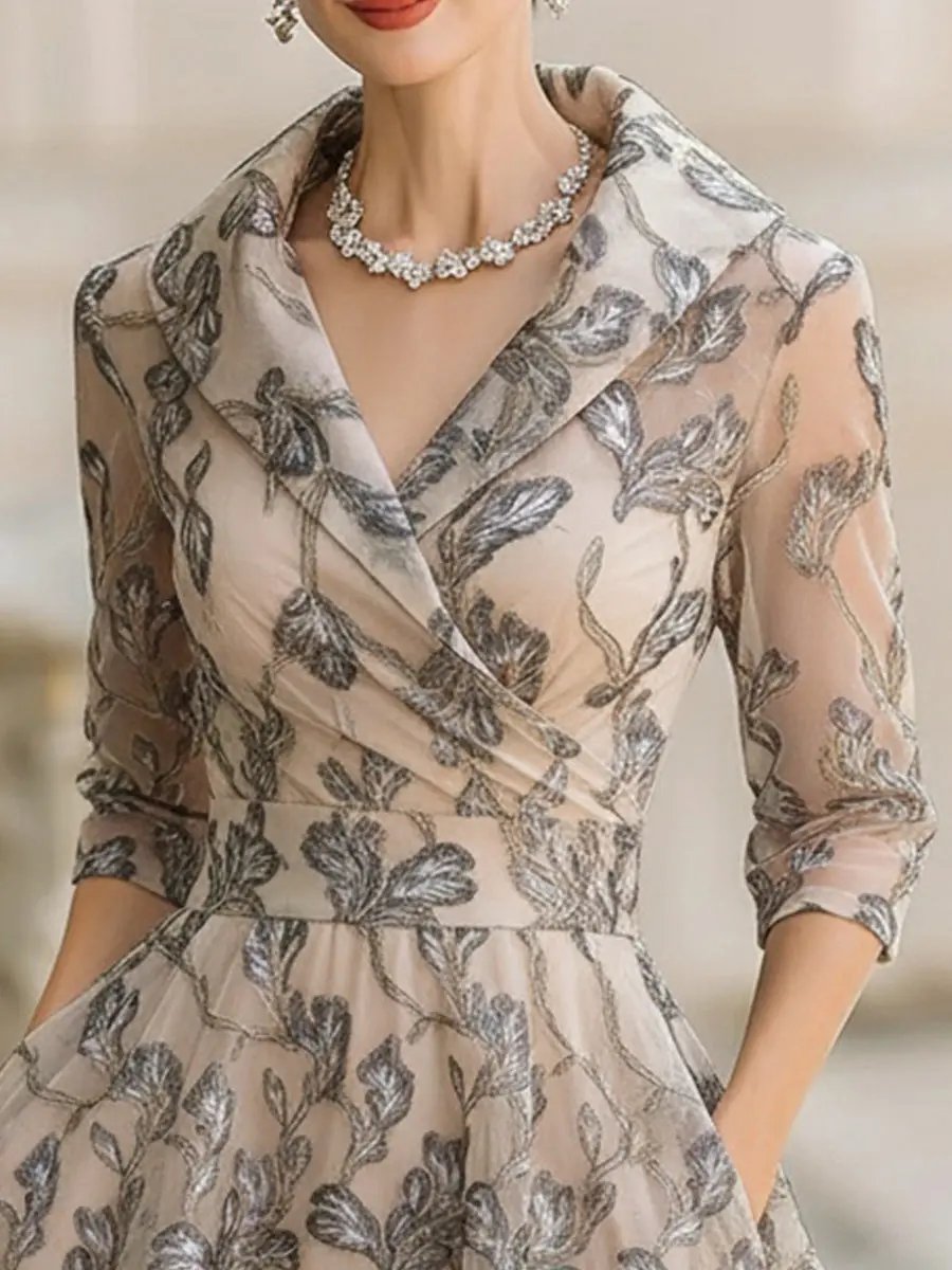 Marceline classic graceful short sleeve midi dress in apricot by THE WHITMORE FAMILY, displayed on a hanger.