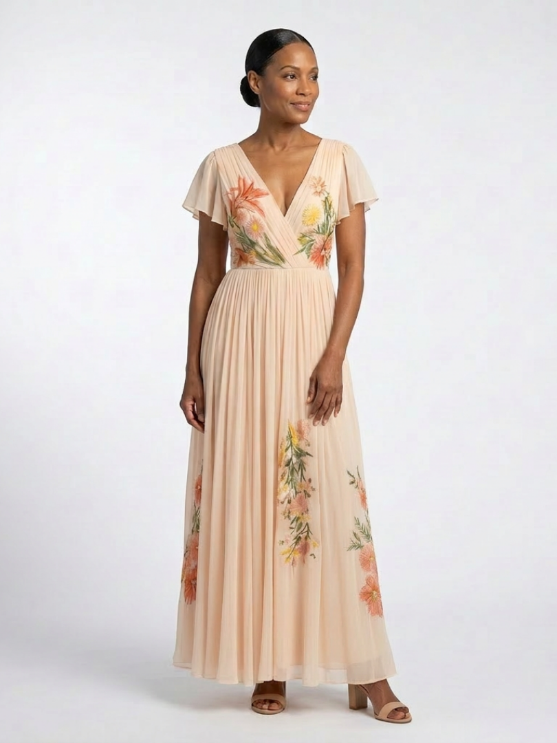 V-neck short sleeve floral maxi dress by THE WHITMORE FAMILY with pleated skirt, in vibrant floral print.