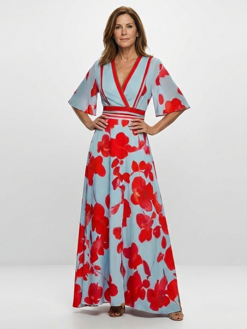 Corinne floral V-neck short sleeve maxi dress by THE WHITMORE FAMILY, featuring a vibrant floral pattern and flowing fabric.