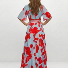 Corinne floral maxi dress by THE WHITMORE FAMILY featuring a V-neck and short sleeves, displayed on a hanger.