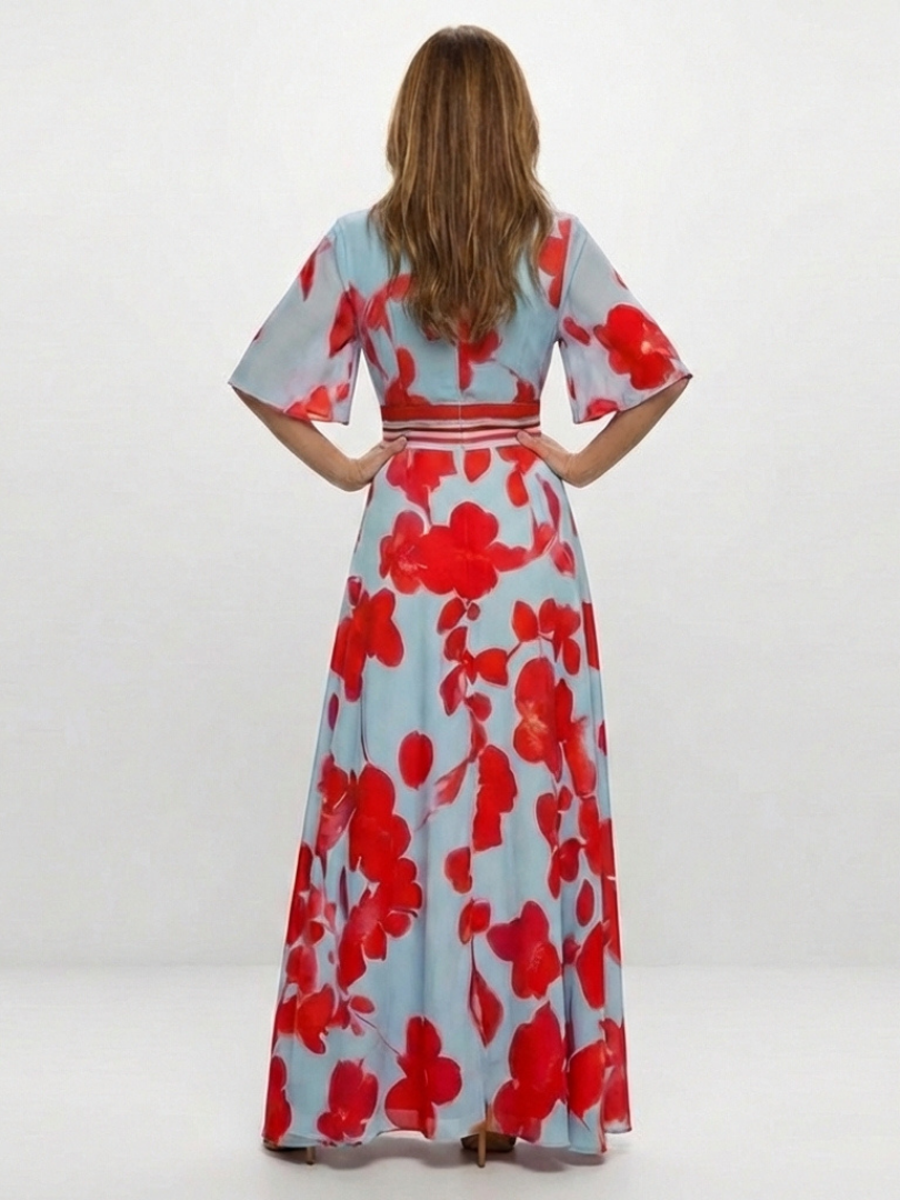 Corinne floral maxi dress by THE WHITMORE FAMILY featuring a V-neck and short sleeves, displayed on a hanger.