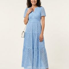 Brielle V-neck short sleeve tiered midi dress by THE WHITMORE FAMILY, shown in a light fabric with a tiered skirt design.