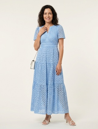Brielle V-neck short sleeve tiered midi dress by THE WHITMORE FAMILY, shown in a light fabric with a tiered skirt design.