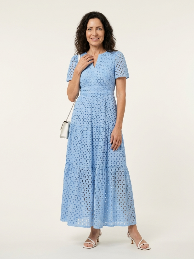 Brielle V-neck short sleeve tiered midi dress by THE WHITMORE FAMILY, shown in a light fabric with a tiered skirt design.