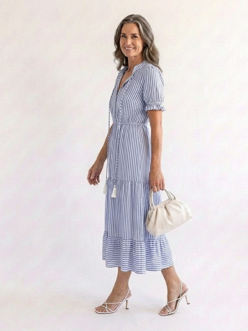 The Whitmore Family Dakota short sleeve striped tiered midi dress with a relaxed fit and vibrant vertical stripe pattern.