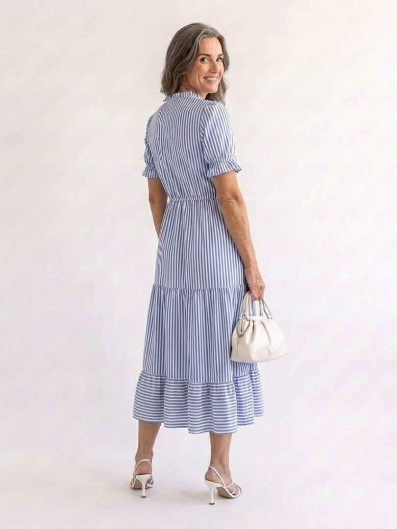 Dakota short sleeve striped tiered midi dress by THE WHITMORE FAMILY, featuring a colorful, flowing tiered design and short sleeves.