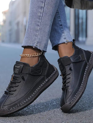 Black Lily™ ergonomic support sneakers by THE WHITMORE FAMILY featuring cushioned insoles and breathable mesh for comfortable walking.