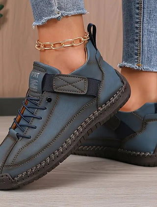 Dark blue Inès™ ergonomic support sneakers by THE WHITMORE FAMILY, featuring cushioned insoles and supportive design for comfort.
