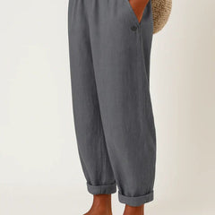 Romina™ linen-cotton trousers by THE WHITMORE FAMILY, shown in natural beige with a relaxed fit and front pockets.