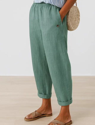 Romina™ linen-cotton trousers by THE WHITMORE FAMILY, featuring a relaxed fit and classic style in neutral fabric.