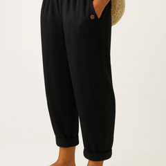 Sharona black linen-cotton trousers from THE WHITMORE FAMILY with a relaxed fit and tailored design, displayed on a neutral background.