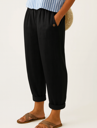 Sharona black linen-cotton trousers from THE WHITMORE FAMILY with a relaxed fit and tailored design, displayed on a neutral background.
