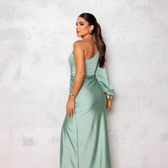 Turquoise stylish elegant dress by THE WHITMORE FAMILY, featuring a fitted silhouette and intricate detailing, perfect for formal occasions.