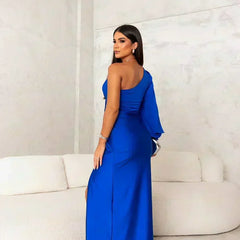 Turquoise Riley one-shoulder evening maxi dress by THE WHITMORE FAMILY, flowing fabric and elegant design for formal occasions.