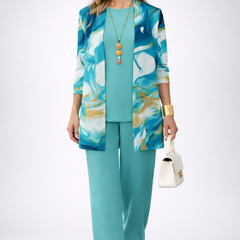 Refined three-piece trouser set by The Whitmore Family featuring tailored trousers, a matching blazer, and a stylish top.