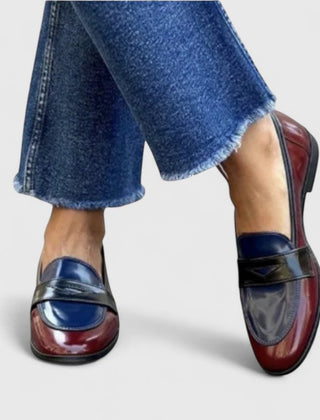 White Flixie Elegant Loafers by THE WHITMORE FAMILY, showing stylish slip-on shoes with a sleek design and smooth leather finish.