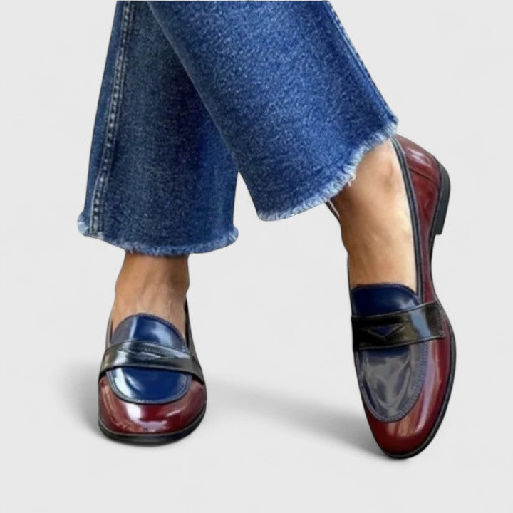 White Flixie Elegant Loafers by THE WHITMORE FAMILY, showing stylish slip-on shoes with a sleek design and smooth leather finish.