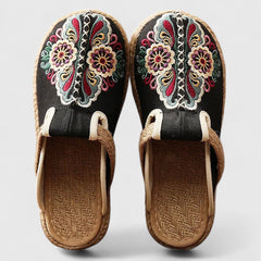White Marousse™ handmade floral mules by THE WHITMORE FAMILY, featuring comfortable design and intricate floral details.