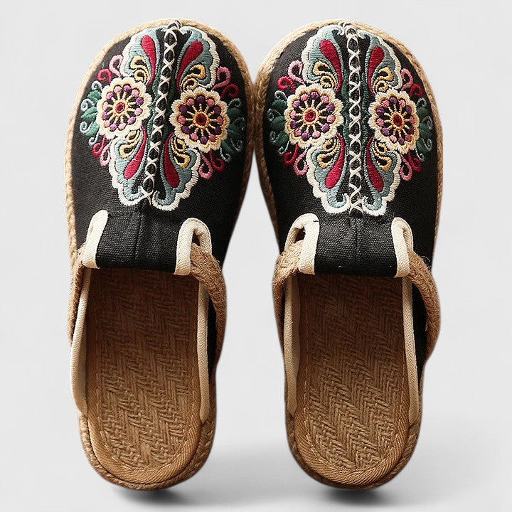 White Marousse™ handmade floral mules by THE WHITMORE FAMILY, featuring comfortable design and intricate floral details.
