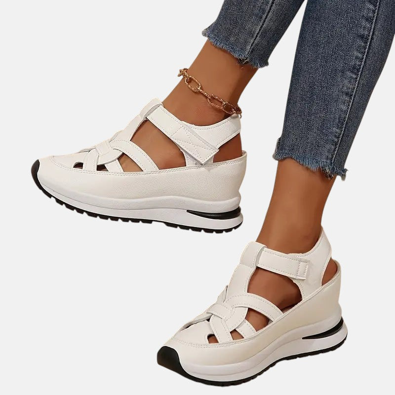White Aveta™ orthopedic sandals by THE WHITMORE FAMILY featuring cushioned soles and adjustable straps for comfortable support.
