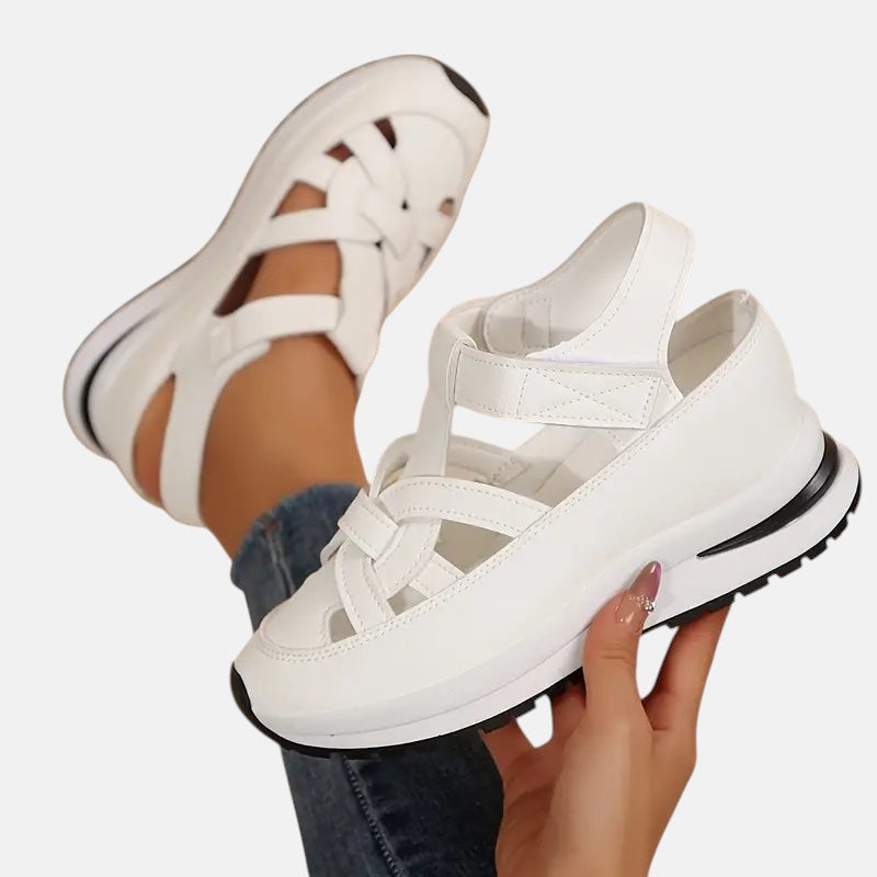 White Aveta™ orthopedic sandals by THE WHITMORE FAMILY featuring supportive straps and cushioned soles for comfort.