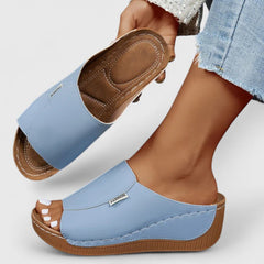 White Celestria™ orthopedic sandals by THE WHITMORE FAMILY with cushioned soles and supportive straps, designed for comfort.