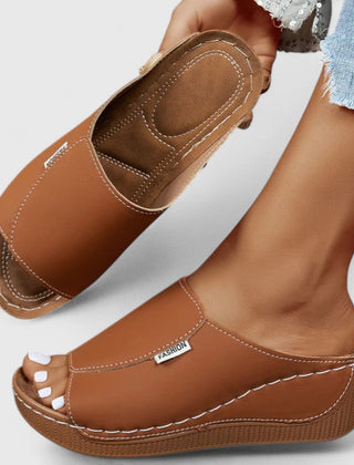 White Celestria™ orthopedic sandals by THE WHITMORE FAMILY, showcasing cushioned straps and supportive sole for comfortable wear.