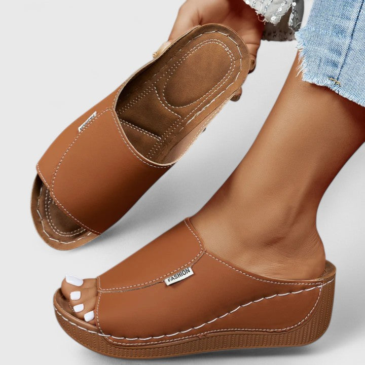 White Celestria™ orthopedic sandals by THE WHITMORE FAMILY, showcasing cushioned straps and supportive sole for comfortable wear.