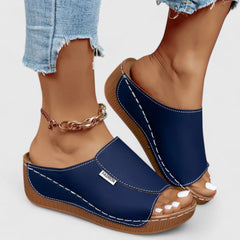 White Celestria™ orthopedic sandals by THE WHITMORE FAMILY with cushioned soles and supportive straps for comfortable wear.