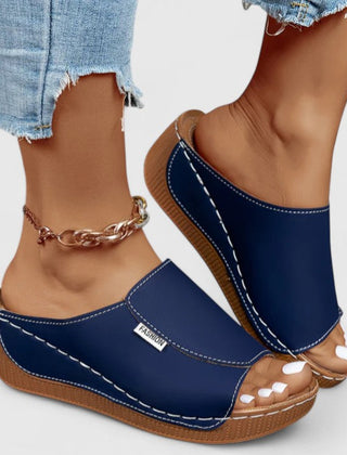 White Celestria™ orthopedic sandals by THE WHITMORE FAMILY with cushioned soles and supportive straps for comfortable wear.
