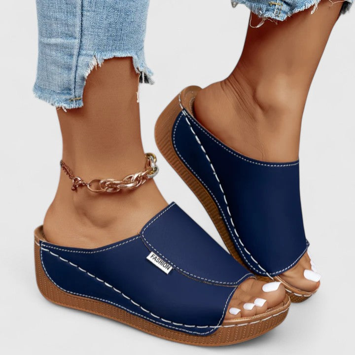 White Celestria™ orthopedic sandals by THE WHITMORE FAMILY with cushioned soles and supportive straps for comfortable wear.