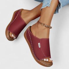 White Celestria™ orthopedic sandals by THE WHITMORE FAMILY with cushioned straps and supportive soles for comfort.