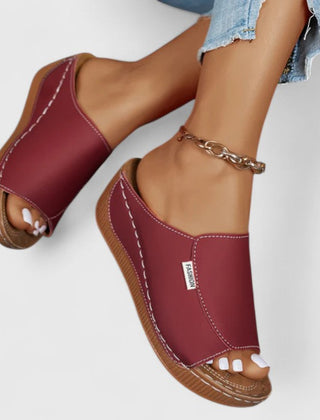 White Celestria™ orthopedic sandals by THE WHITMORE FAMILY with cushioned straps and supportive soles for comfort.